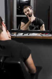reflection-man-grooming-his-beard-mirror